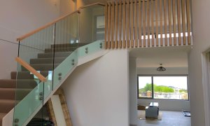 Panar balustrade with stainless steel buttons and timber linear handrail